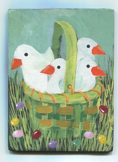 Folk-art painting of four white geese with orange bills peeking out of a green woven basket, surrounded by grass and colorful jelly-bean eggs.