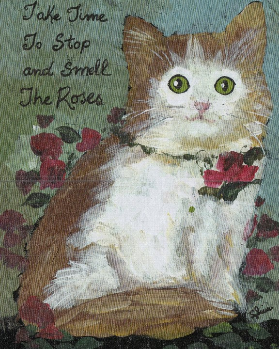 Painting of a wide-eyed brown and white kitten wearing a rose vine collar among red roses, with the hand-lettered words 'Take Time To Stop and Smell The Roses'.
